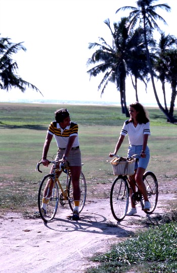 Man and woman bicycling on a sandy path