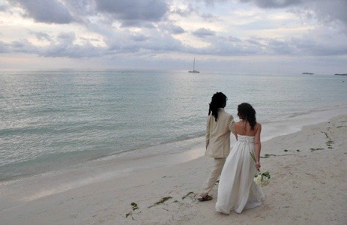 Bride and Groom Strolling on the Beach